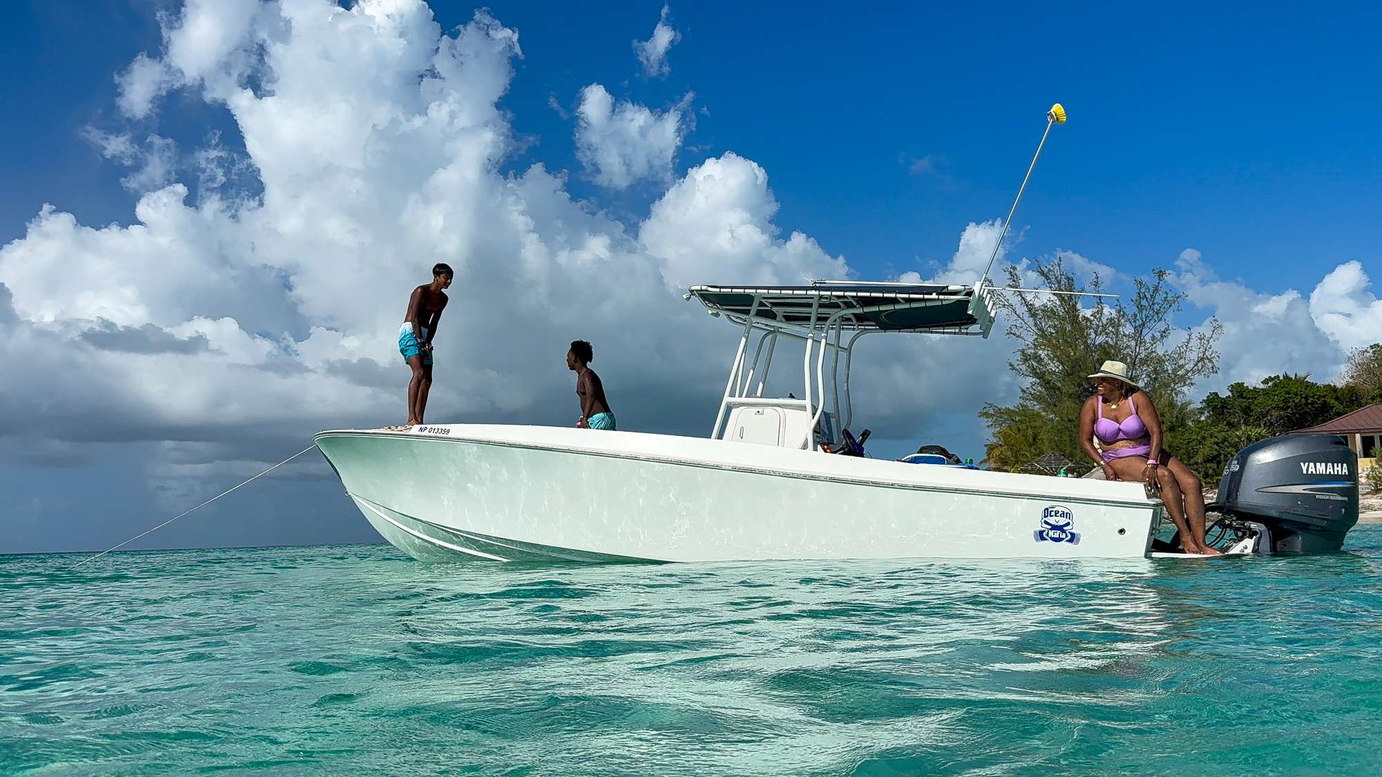 Family enjoying a private boat charter in Nassau, Bahamas with time to swim and relax at their own pace.