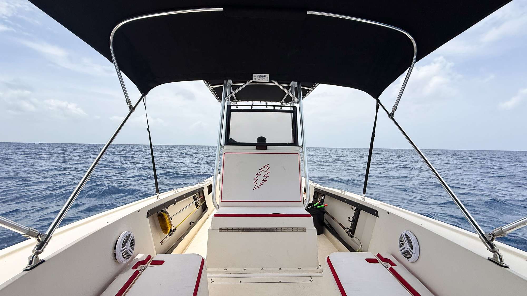 Forever the Co, a 1988 Mako 231B private boat charter in Nassau, Bahamas, anchored in the crystal-clear waters of Rose Island.