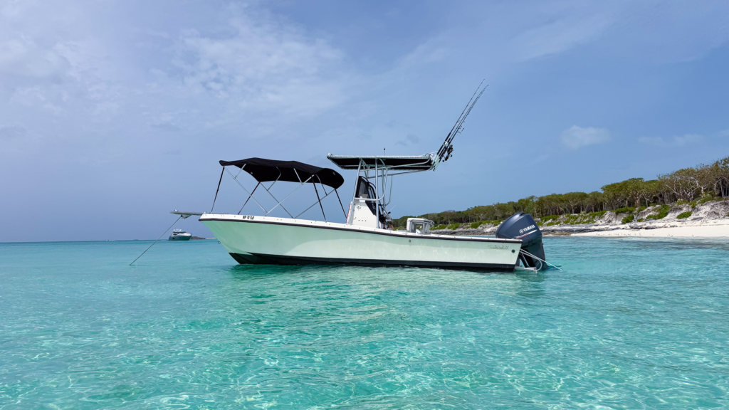 Forever the Co, a 1988 Mako 231B private boat charter in Nassau, Bahamas, anchored in the crystal-clear waters of Rose Island.