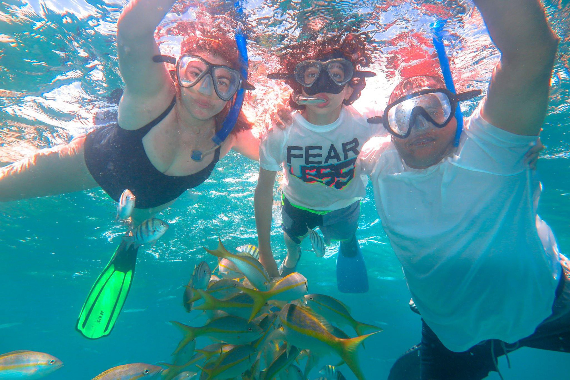 Guests snorkeling with tropical fish in Nassau Bahamas